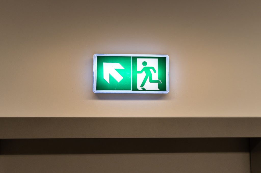 Balisage lumineux de sortie de secours installé au-dessus d'une porte dans un restaurant à Douala